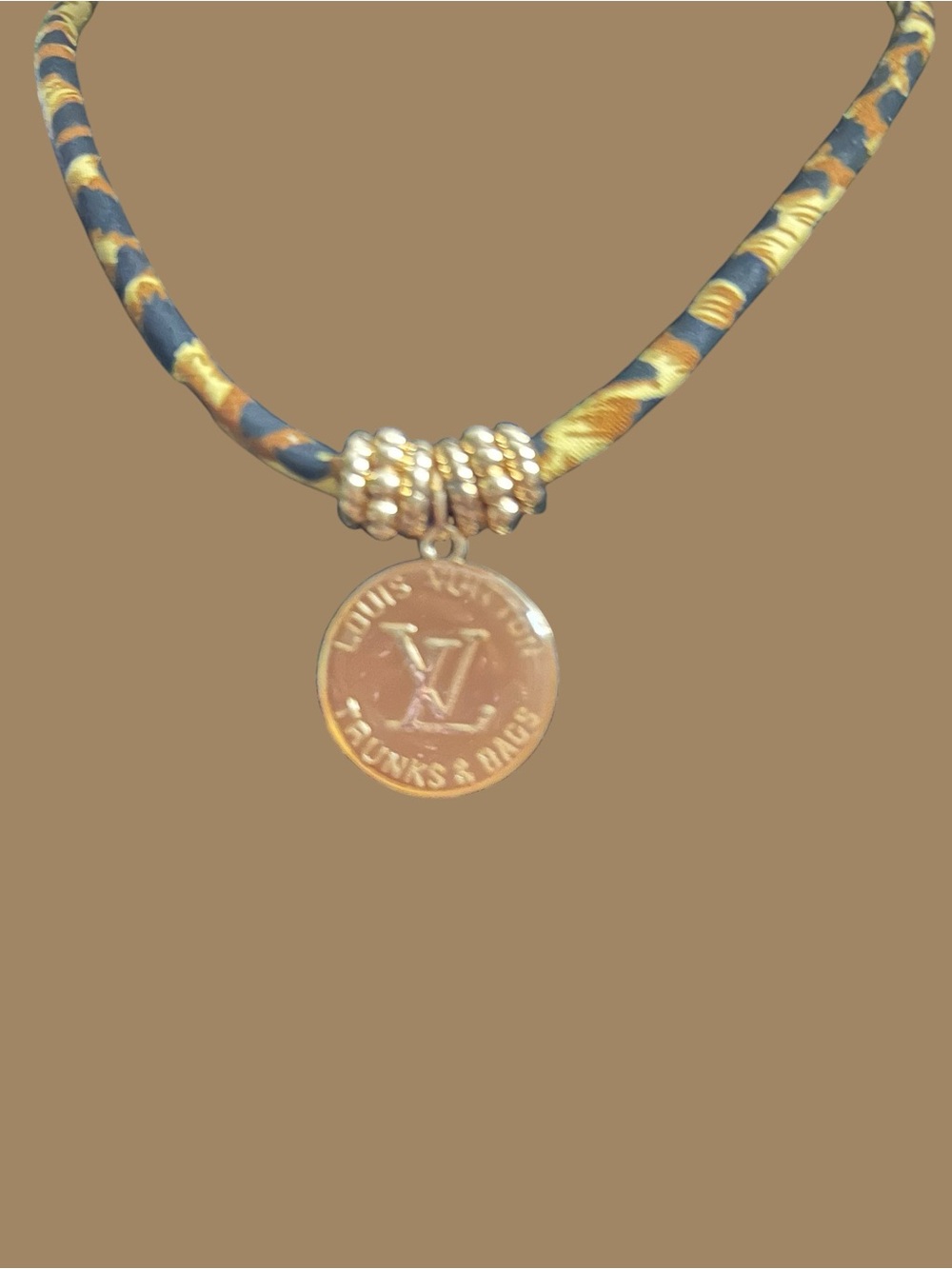 Gold Medallion Necklace on Patterned Blue & Gold Cord